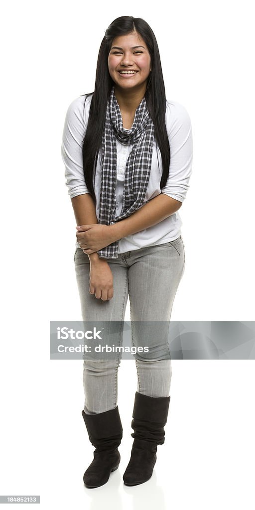 Happy Young Woman Standing Portrait of a young woman on a white background. 16-17 Years Stock Photo