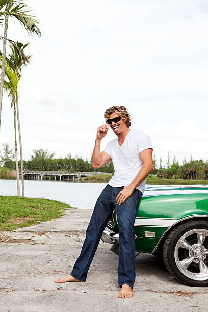 istock Young man smiling with car 184853560