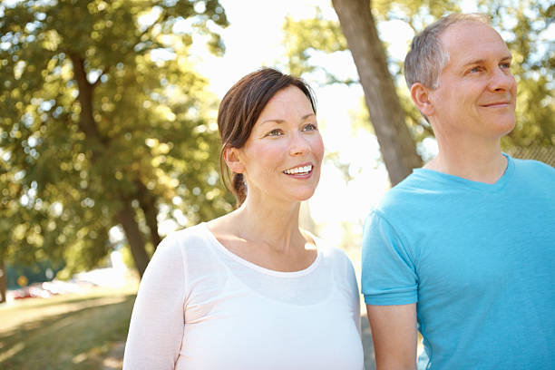 istock Mature couple walking in the park 184853629