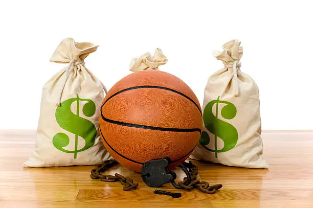 Concept-NBA Lockout. Basketball sitting on hardwood court with a money bag, chain and padlock