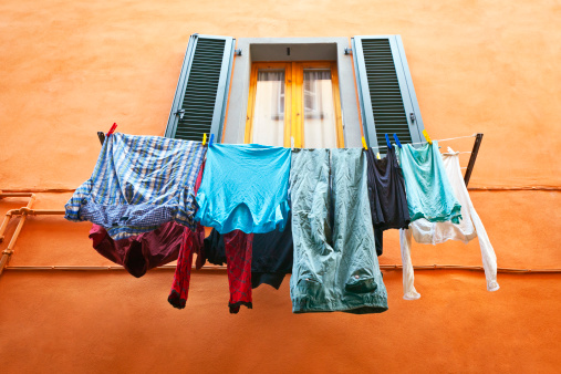 Italy: hanging lanundry drying on a window.