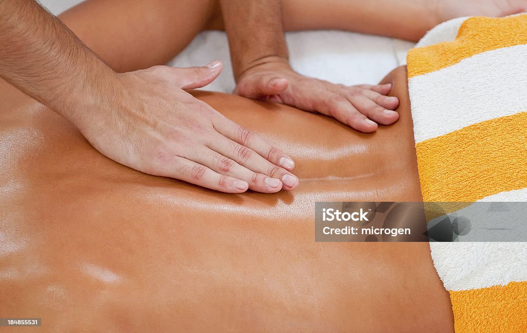 Massage of lumbosacral area Massaging lumbosacral area on the back Adult Stock Photo