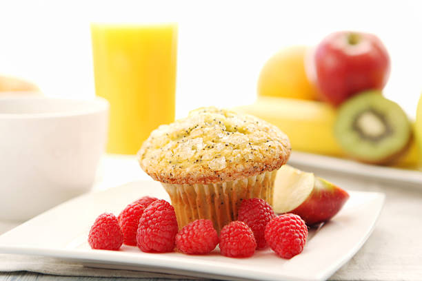 A butter pecan coffee cake muffin with fried eggs and sausage