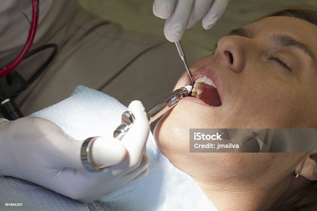 Dentist Dentist applying lidocaine to patient before procedure Accuracy Stock Photo