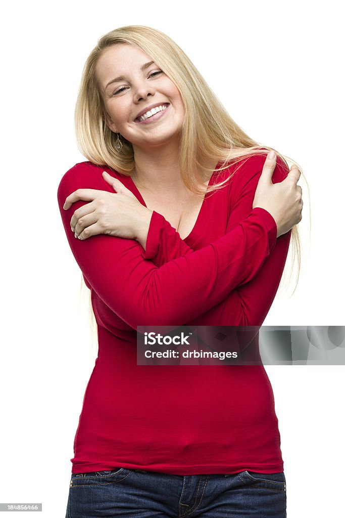 Happy Young Woman Hugging Herself Portrait of a young woman on a white background. Embracing Stock Photo