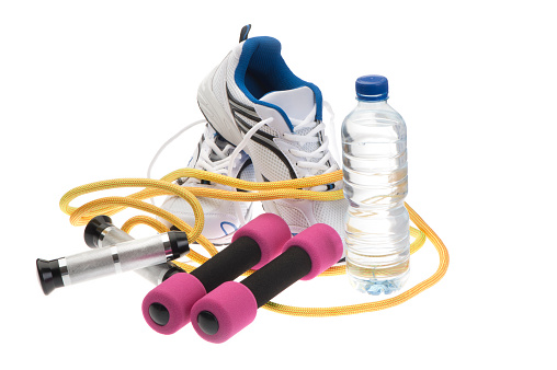 Sport shoes, skipping rope; dumbbells and water bottle isolated on white