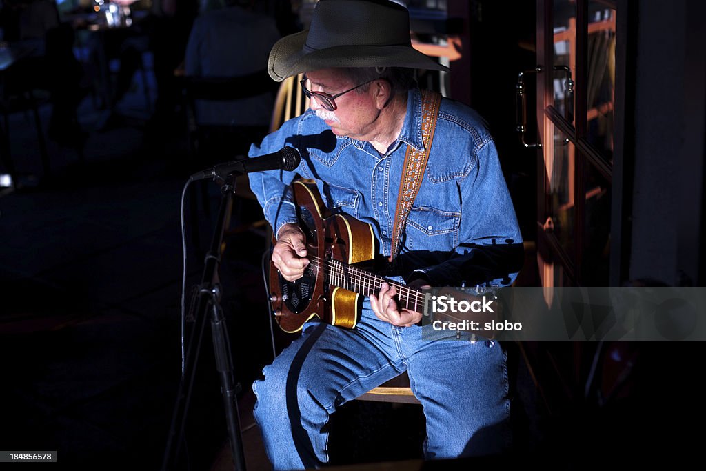 Old Man Blues Older man playing and singing blues on stage. Stage - Performance Space Stock Photo