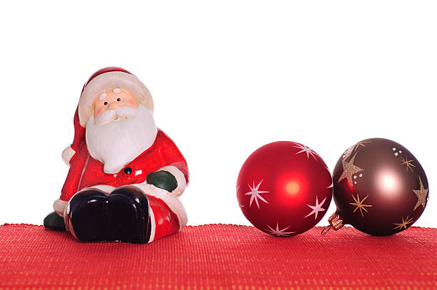 Santa Claus on red textile with christmas ballStudio Shot with white background - no manual isolation
