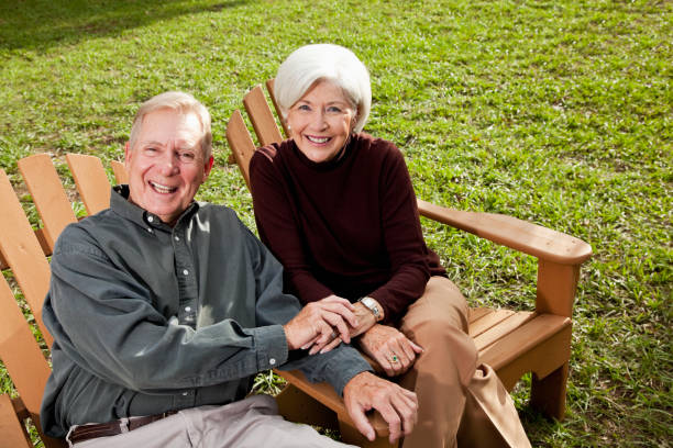 istock Senior couple sitting on adirondack chairs 184857272