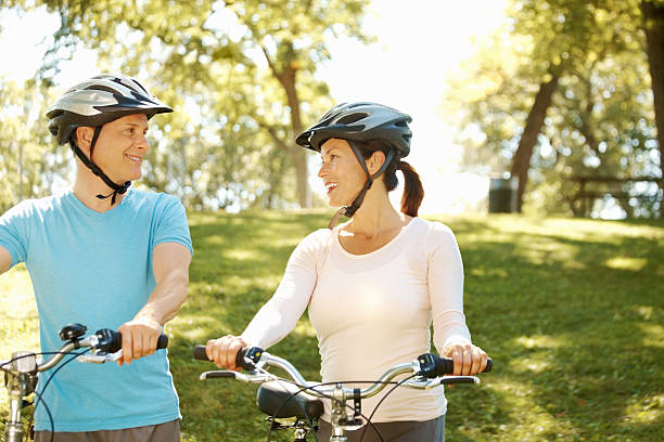 istock Smiling couple bicycling together 184857273