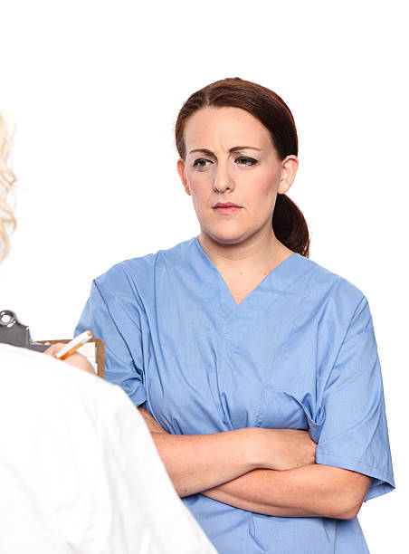 Woman in Scrubs shows concern stock photo