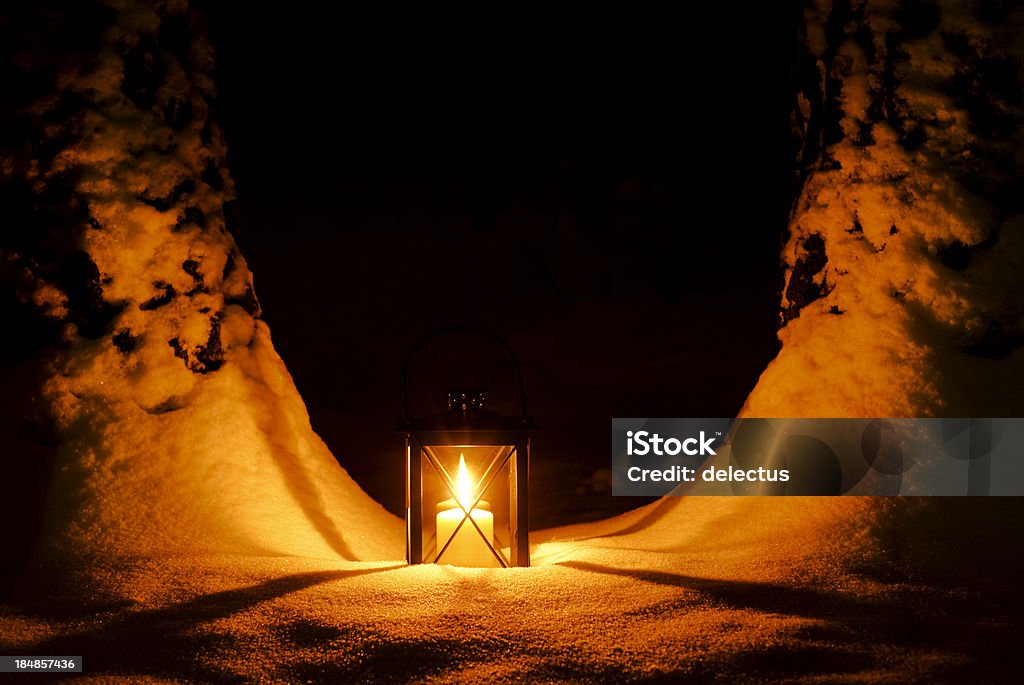 Lantern in snow Lantern in snow, with warm candlelight. Lantern Stock Photo