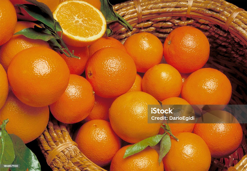 Composition with oranges in and out a wicker basket  Valencia Orange Stock Photo