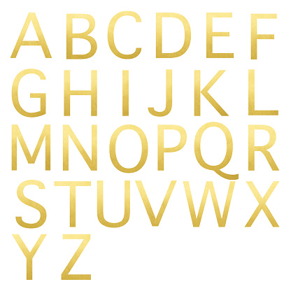Close-up of gold alphabet on white background.