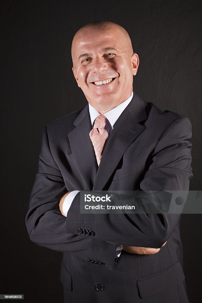 Ritratto di un uomo d'affari senior sorridente - Foto stock royalty-free di 50-54 anni