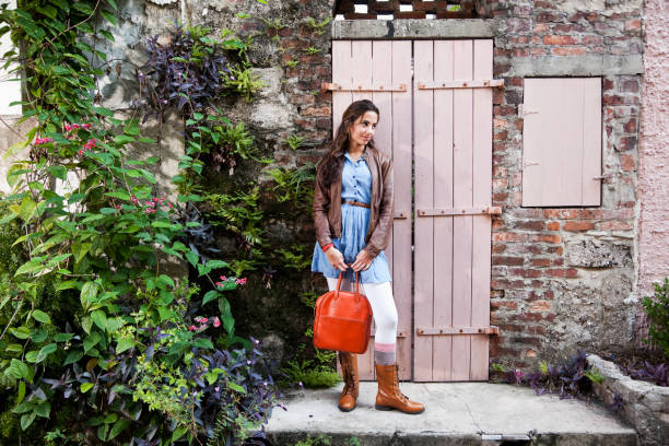 Teenage girl standing outside rustic building
