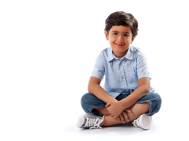 Smiling 6 Year Old Boy Sitting Cross Legged