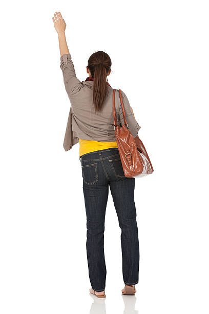 vista posterior de una mujer agitando sus manos - waving arms fotografías e imágenes de stock