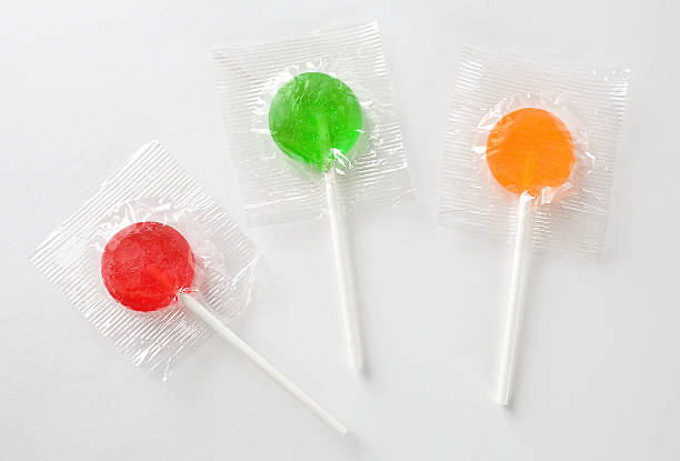 istock Red green and orange lollipops in their wrappers. 184860601