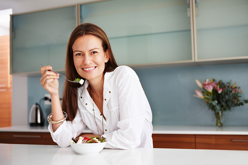 Woman having healthy meal in her house
