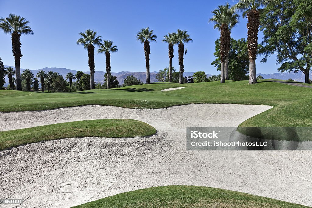 Sand Trap Large Sand Trap surrounds the putting green on resort golf course in Palm Desert California California Stock Photo