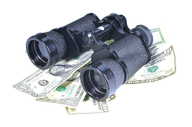 looking for money - binoculars on dollars binoculars on money isolated on white ausschau halten stock pictures, royalty-free photos & images