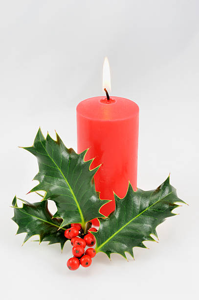 istock Red Christmas candle with holly. 184861617