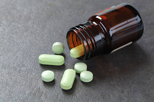 istock Pills pouring out of a bottle 184862723