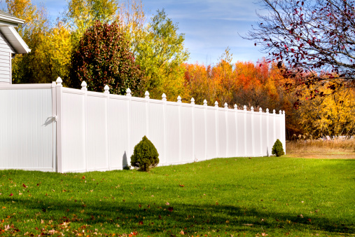 Photo of a new white vinyl fence in yard
