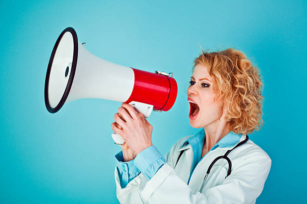 istock Female doctor shouting into megaphone 184863071