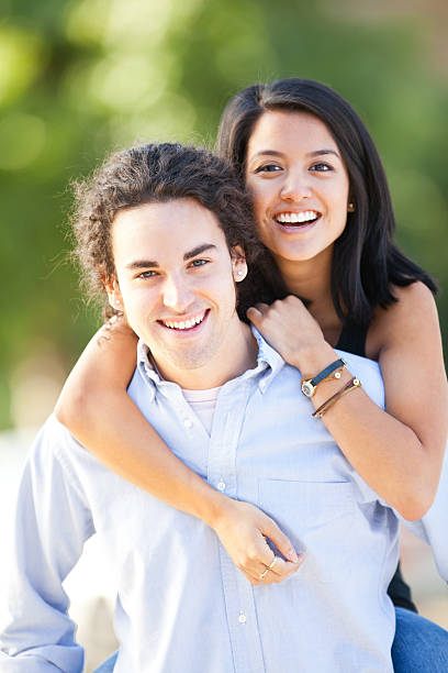 istock girlfriend on boyfriend's back portrait 184863388