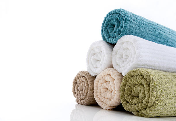 High angle view of a stack of three new blue towels isolated on white background. High resolution 42Mp studio digital capture taken with Sony A7rII and Sony FE 90mm f2.8 macro G OSS lens