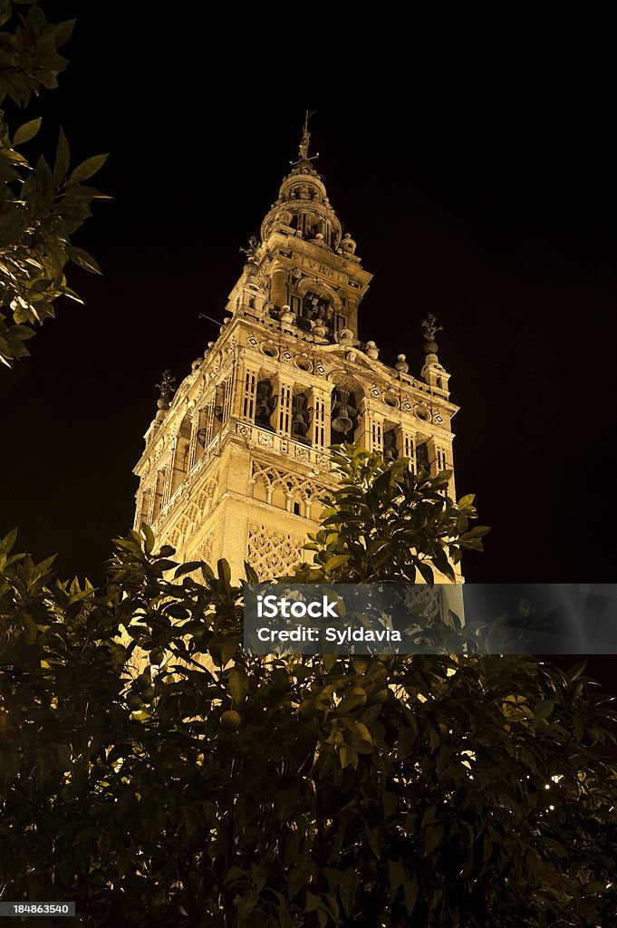 Spanish building. Sevilla "The Giralda tower, part of the Cathedral in Seville, Spain. Orginally the tower Was a minaret on the Almohad mosque, converted to WAS and a bell tower After the Reconquista." Andalusia Stock Photo