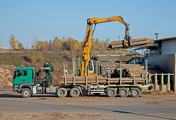 truck transporting several large wooden piece
