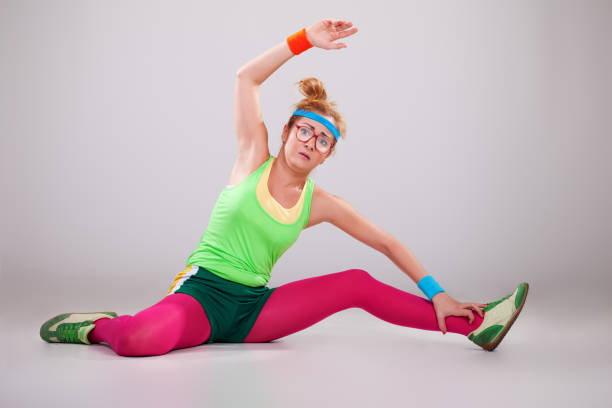 Clumsy fitness girl doing exercises stock photo