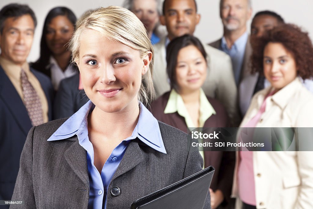 Confident businesswoman in front of diverse business team Confident businesswoman in front of diverse business team. Achievement Stock Photo