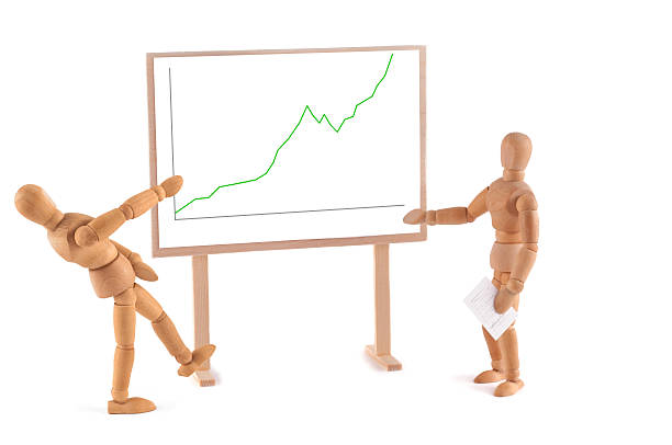 istock Wooden Mannequin and business graph 184864365