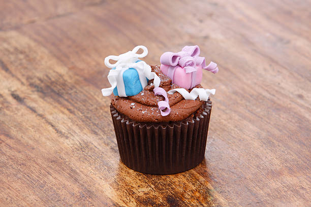 istock Gift Decorated Cupcake on Wooden Background 184864374