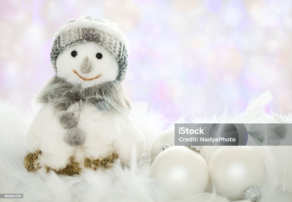 Christmas Decoration Cute dressed up snowman and Christmas balls in the snow. Backgrounds Stock Photo