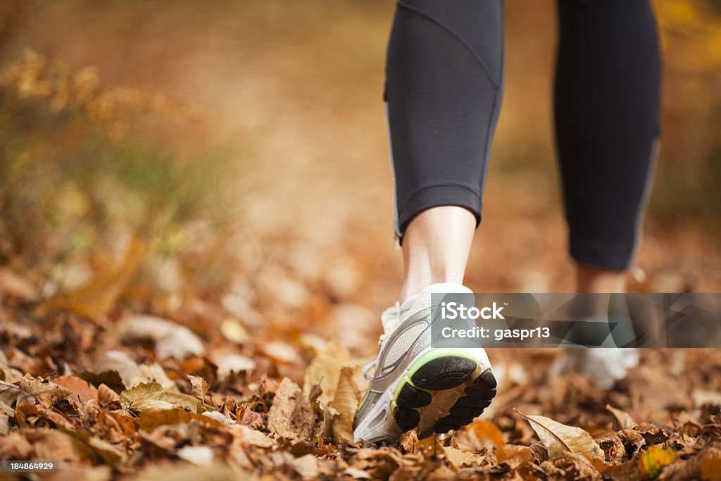 autumn running closeup of a women's running shoe treads on a autumn forest footpathCHECK OTHER SIMILAR IMAGES IN MY PORTFOLIO.... Racewalking Stock Photo