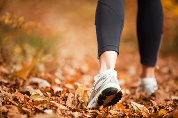 autumn running closeup of a women's running shoe treads on a autumn forest footpathCHECK OTHER SIMILAR IMAGES IN MY PORTFOLIO.... racewalking photos stock pictures, royalty-free photos & images