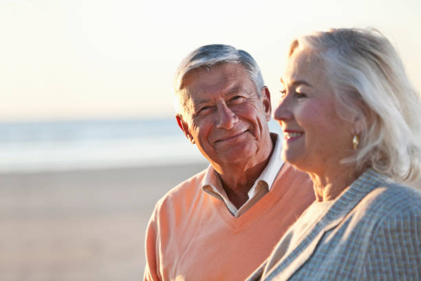 istock Senior couple standing on beach 184865098