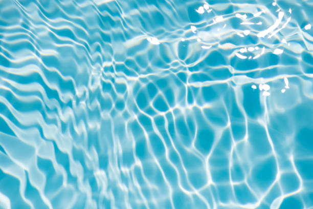 istock Bluewater bubbles on the surface ripples. Defocus blurred transparent white-black colored clear calm water surface texture with splash and bubbles. Water waves with shining pattern texture background 1848651226