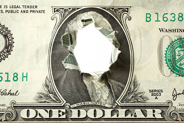 Hole Punched Through Dollar Bill stock photo