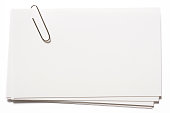Stacked blank white cards with paper clip on white background