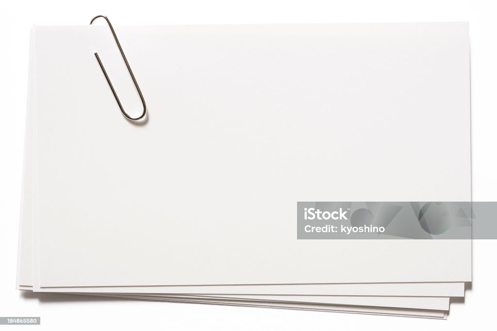Stacked blank white cards with paper clip on white background Stacked blank cards with a paper clip, isolated on white background with clipping path. Paper Clip Stock Photo
