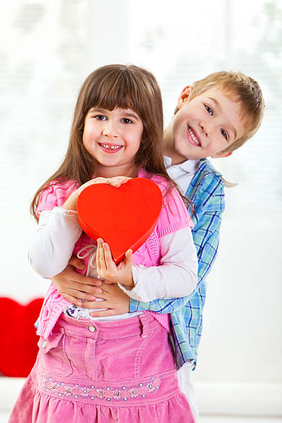 istock Cute little couple with red gift box 184865672