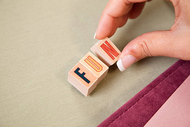 Lady scrapbooking, writing 'fun' with stamps