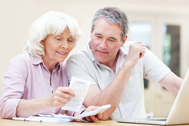 istock Couple calculating domestic bills 184866011