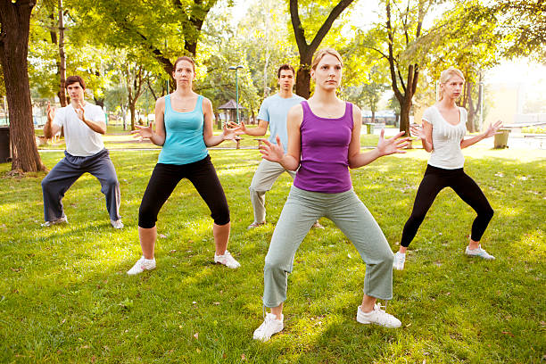 istock Group of Young People Practicing Tai Chi Outdoor 184866169